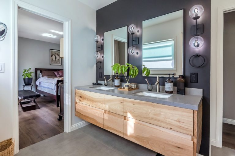 Angled view of floating double vanity beside the bedroom doorway.