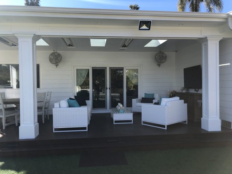 Covered patio front with white columns and lounge furniture.