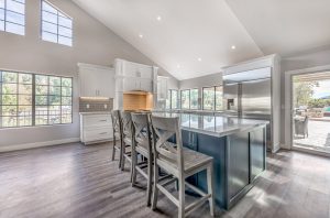 Thousand Oak large white kitchen with grey island with marble countertop