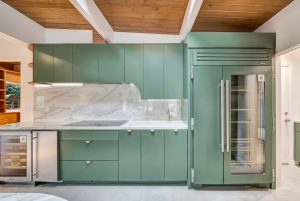 Sage green kitchen cabinetry custom built in uniqie style in Brentwood California