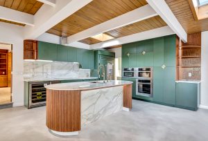 Fluted wood paneling kitchen island and sage green kitchen