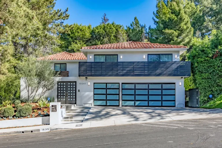 Two-story home exterior with a tiled roof and translucent garage doors.